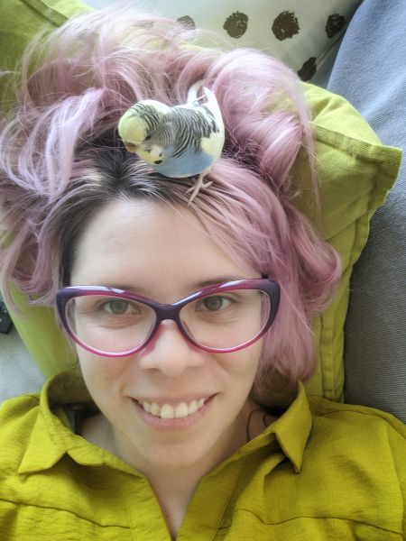 Laura with budgie sitting on her head
